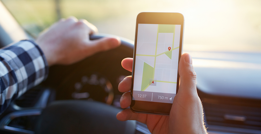Person using Google Maps on a mobile phone to find a local business.